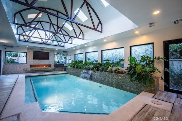 view of pool with a skylight and pool water feature