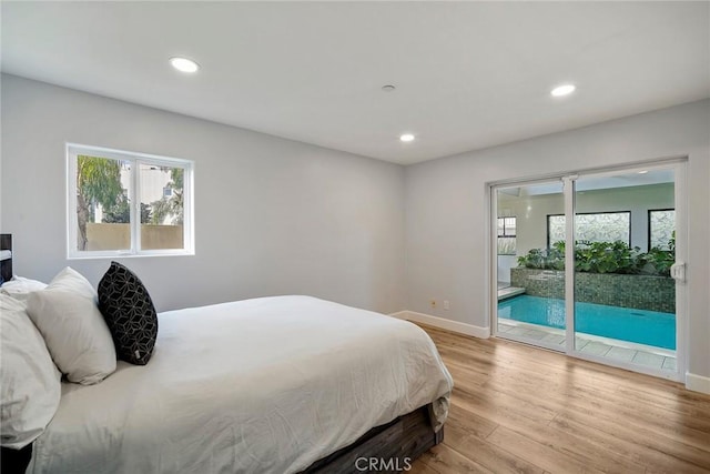 bedroom featuring access to outside and light hardwood / wood-style flooring