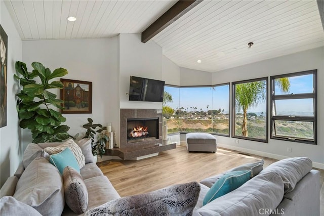 living room featuring wooden ceiling, a high end fireplace, hardwood / wood-style floors, and vaulted ceiling with beams