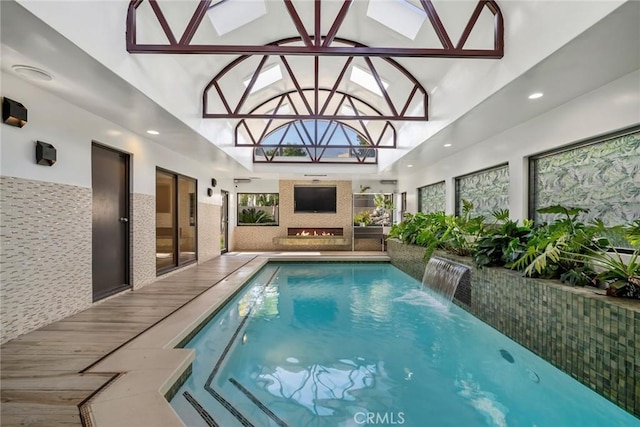 view of pool with a skylight and pool water feature