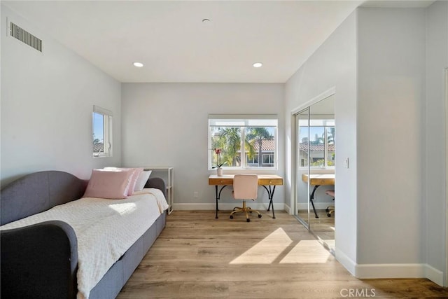 bedroom featuring light hardwood / wood-style floors and a closet