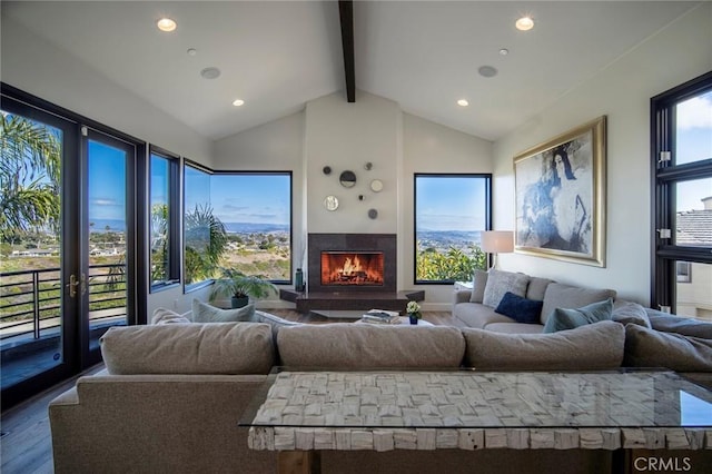 living room with hardwood / wood-style floors, plenty of natural light, and lofted ceiling with beams