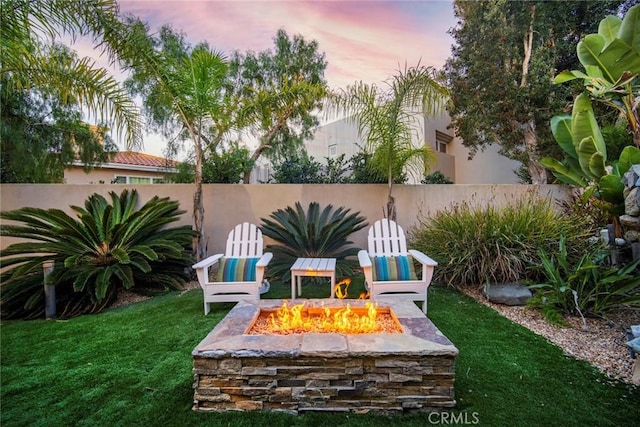 yard at dusk with an outdoor fire pit