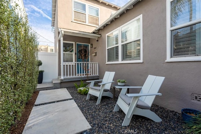 rear view of property featuring covered porch