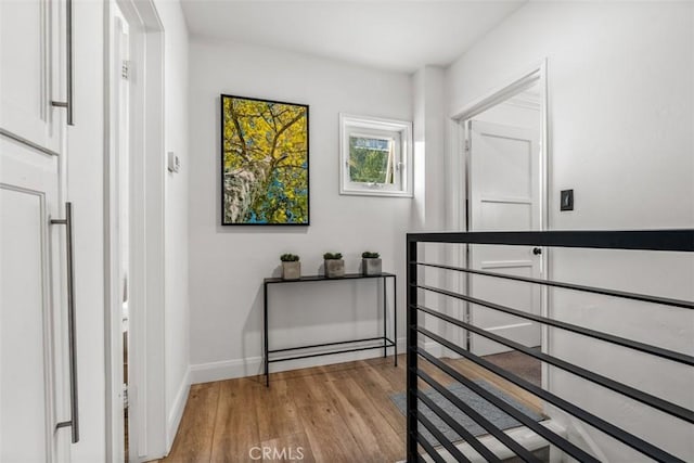 corridor with light hardwood / wood-style floors