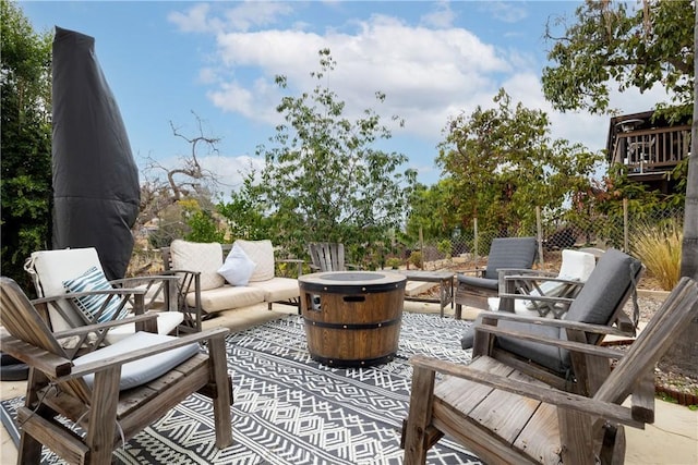 view of patio / terrace with an outdoor living space with a fire pit