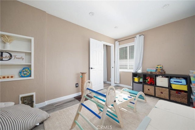 recreation room with light wood-type flooring