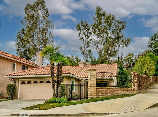 mediterranean / spanish house with a garage