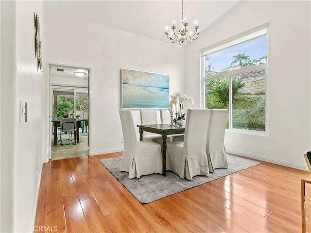 unfurnished dining area featuring hardwood / wood-style floors and an inviting chandelier