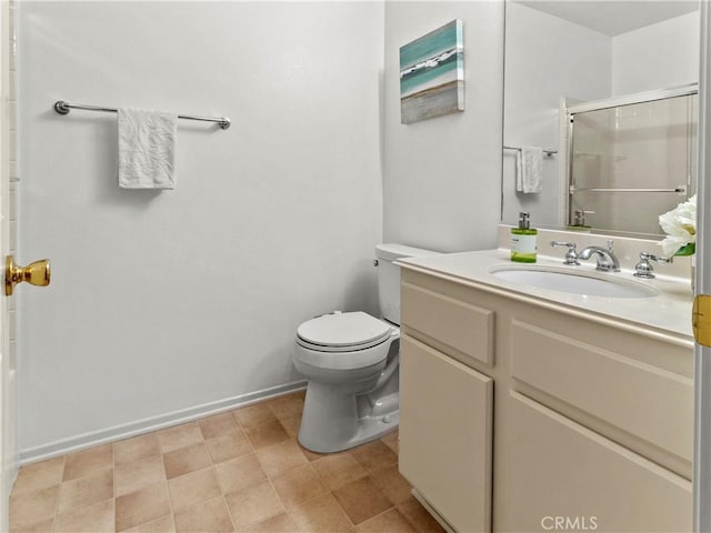 bathroom with toilet, vanity, and a shower with shower door