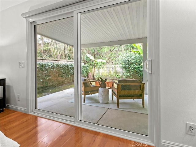 doorway with hardwood / wood-style floors