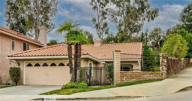 mediterranean / spanish-style house with a garage