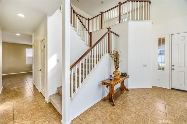 entrance foyer with a high ceiling and light tile patterned floors