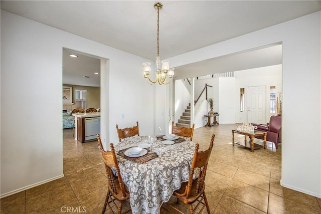 dining space with tile patterned flooring and a chandelier