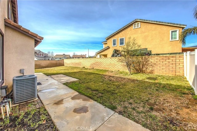 view of yard with a patio and central air condition unit