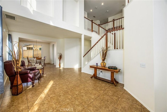 interior space featuring tile patterned flooring and a high ceiling