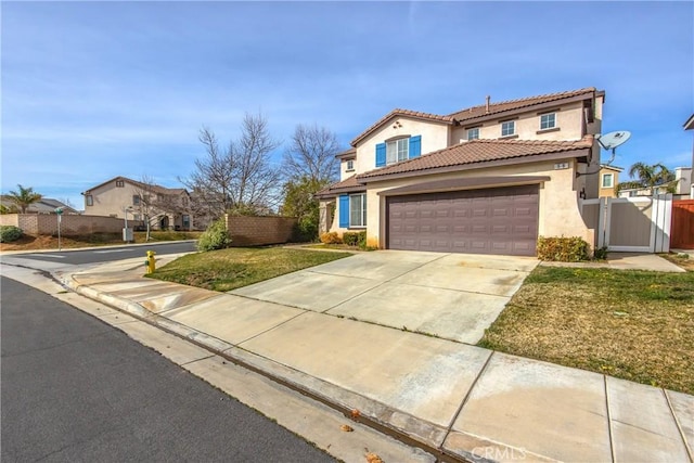 mediterranean / spanish house with a garage and a front lawn