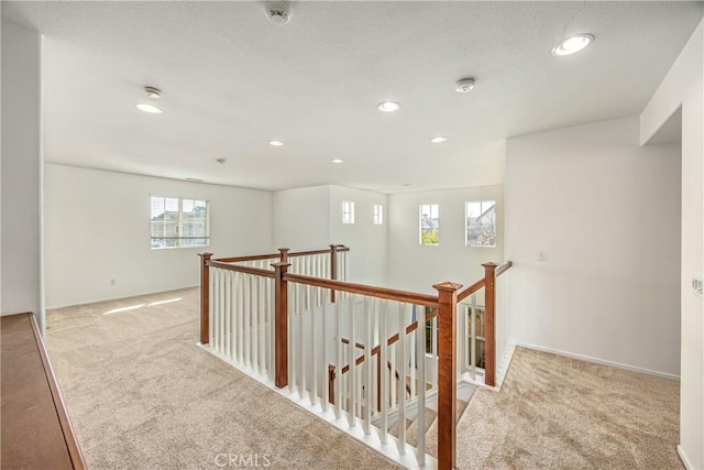 hallway featuring light carpet