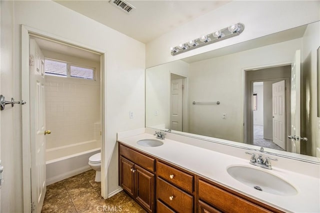 full bathroom featuring vanity, tile patterned floors, toilet, and shower / washtub combination