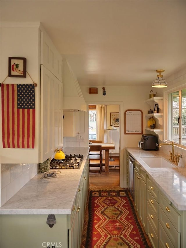 kitchen with dark wood-type flooring, sink, custom exhaust hood, appliances with stainless steel finishes, and backsplash