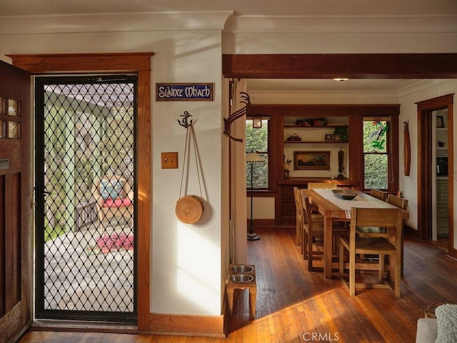 interior space featuring dark wood-type flooring and ornamental molding