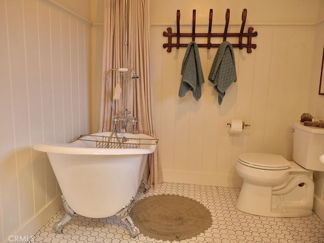 bathroom featuring toilet, tile patterned flooring, and a washtub