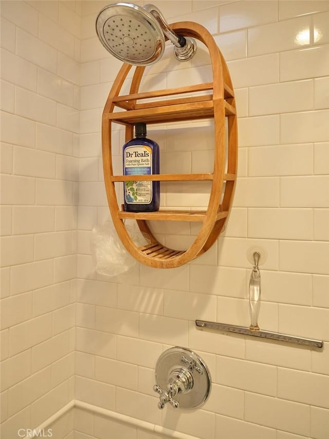 interior details featuring a tile shower