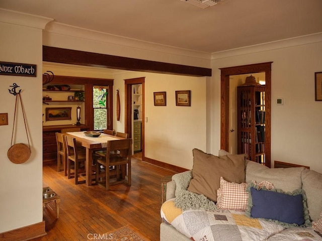 living room featuring ornamental molding and dark hardwood / wood-style flooring