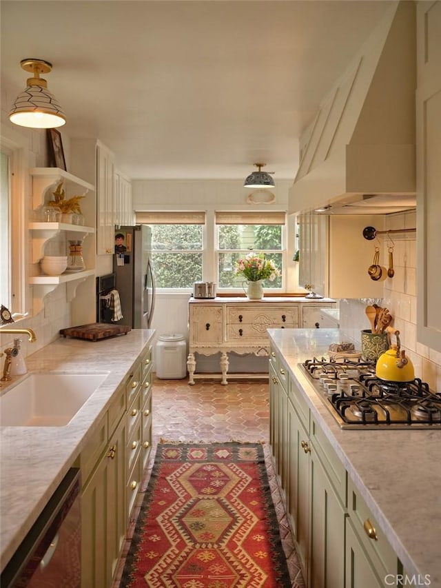 kitchen with appliances with stainless steel finishes, sink, custom range hood, and backsplash