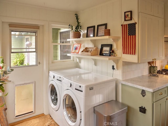 laundry area featuring separate washer and dryer and crown molding