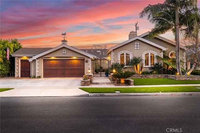 single story home with a garage and a lawn