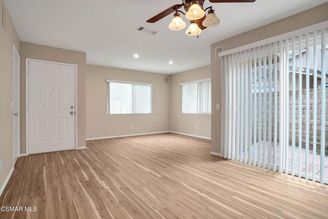 unfurnished room with ceiling fan and light wood-type flooring