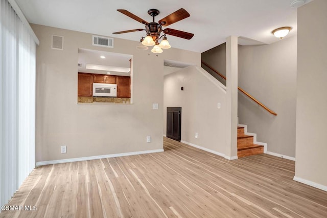 unfurnished living room with ceiling fan and light hardwood / wood-style flooring