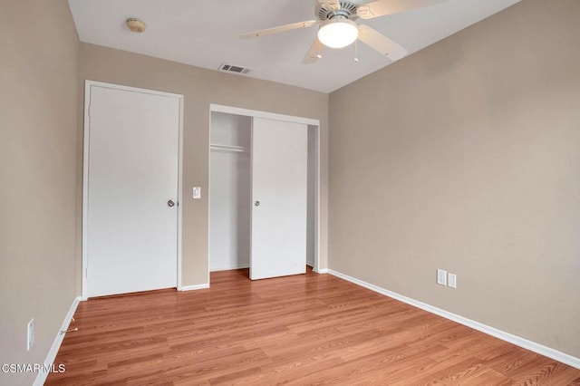 unfurnished bedroom with ceiling fan, light hardwood / wood-style floors, and a closet