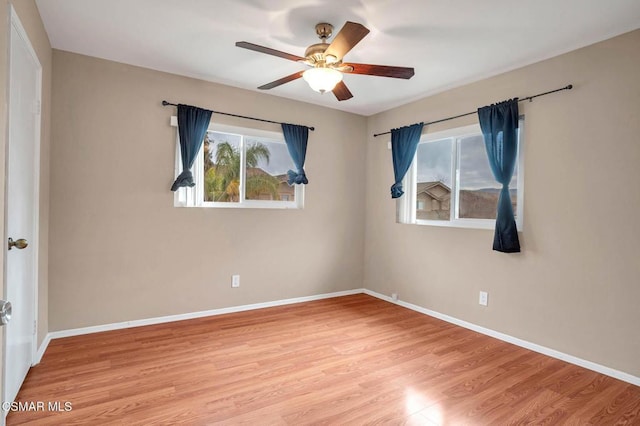 unfurnished room with ceiling fan and light wood-type flooring