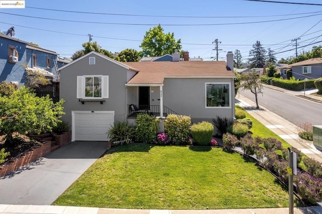 view of front of property featuring a garage and a front yard