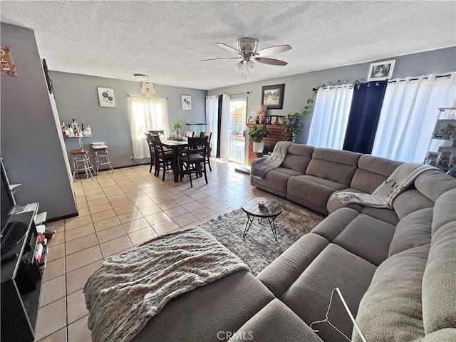 tiled living room featuring ceiling fan and a textured ceiling