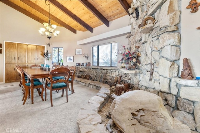 dining room with a notable chandelier, beam ceiling, light colored carpet, and wooden ceiling