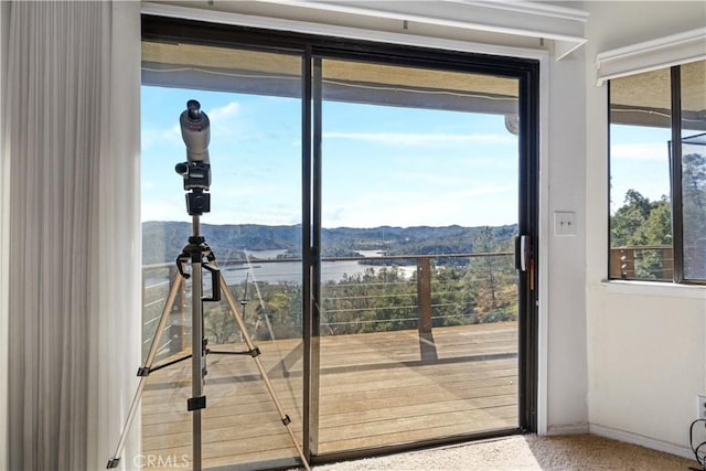 doorway to outside featuring a water and mountain view