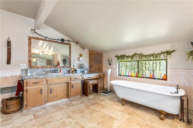 bathroom featuring vanity, a bath, and lofted ceiling with beams