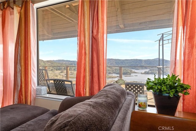 interior space featuring a healthy amount of sunlight and a water and mountain view