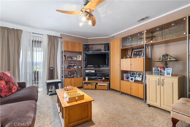 carpeted living room with ceiling fan