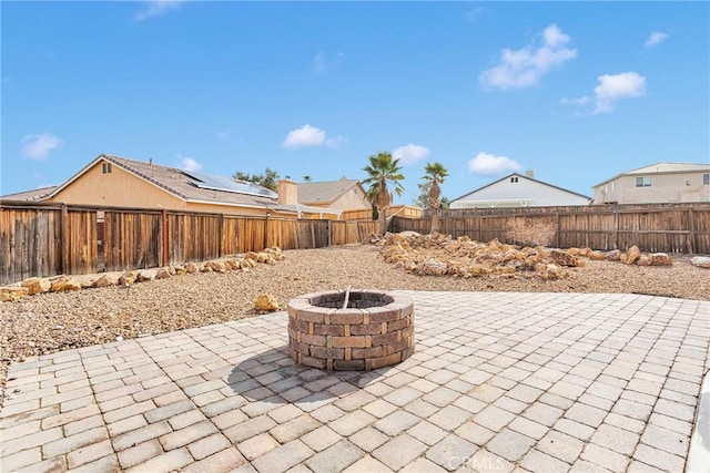 view of patio with a fenced backyard and a fire pit