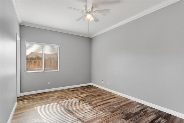 unfurnished room featuring ceiling fan, crown molding, baseboards, and wood finished floors