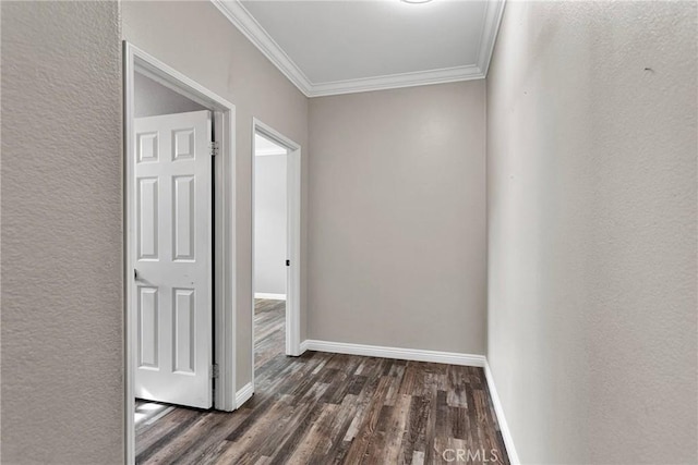 hallway with a textured wall, baseboards, dark wood finished floors, and crown molding