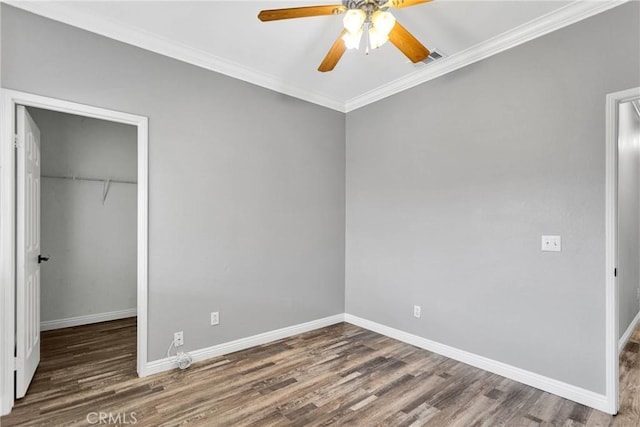 unfurnished bedroom with ornamental molding, dark hardwood / wood-style floors, and a closet