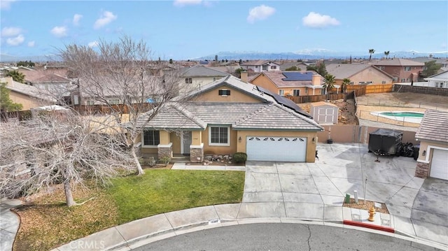 view of front of property featuring fence, concrete driveway, a residential view, stucco siding, and a front lawn