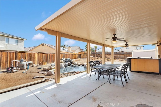 view of patio with ceiling fan, a fenced backyard, and outdoor dining area