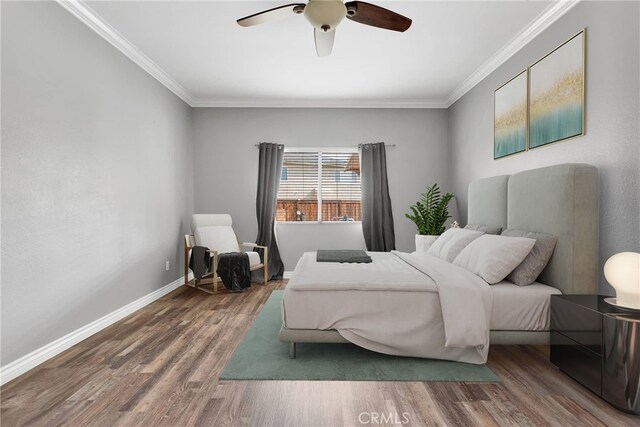 bedroom with ceiling fan, ornamental molding, and wood-type flooring