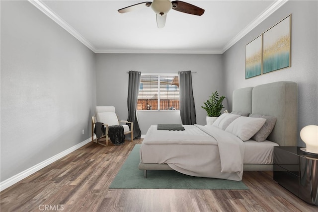 bedroom featuring baseboards, wood finished floors, ornamental molding, and ceiling fan